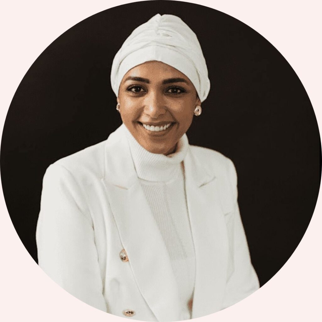Professional headshot of Dr. Eiman Osseilan, team member at Concurrent Wealth Management, wearing a white blazer and head wrap.